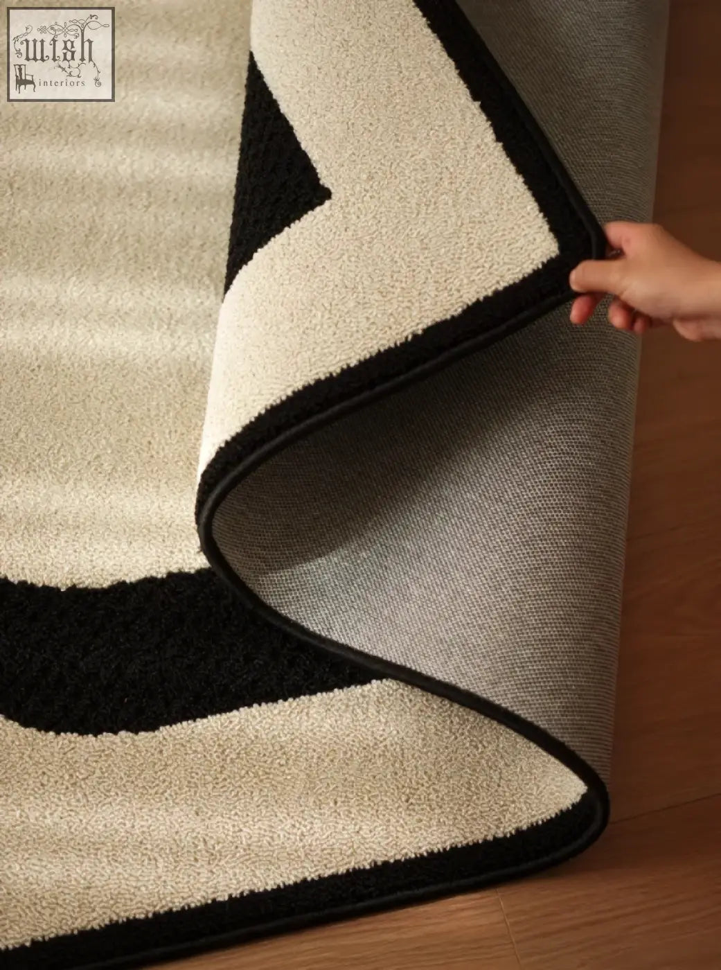 A plush cream and black geometric rogers rectangular living room rug perfect for under a coffee table set or table set