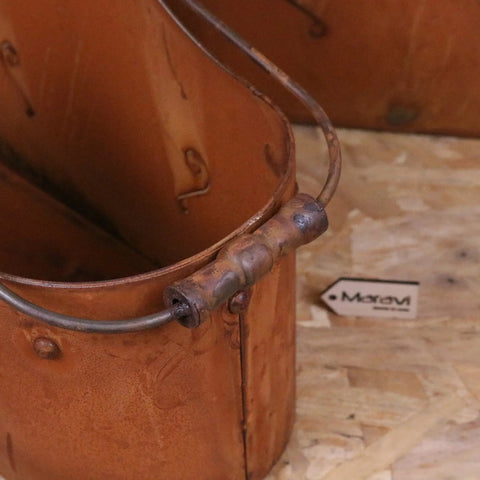 Rustic copper rohira basket style rusty planter with patina finish and sturdy metal handle attached by rivets