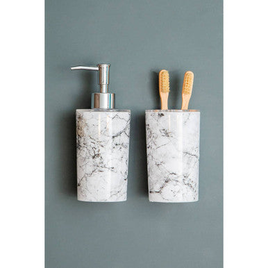 White marble-patterned soap dispenser with silver pump for the rome toothbrush holder set in bath use
