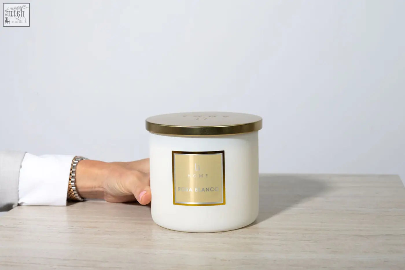 Cream-colored large candle with gold lid and vega blanc scent from rosa blanco 3 wick luxury candle collection