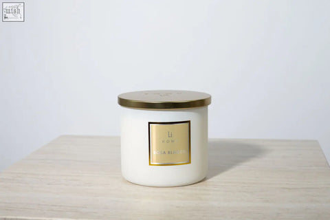 A large 3 wick luxury candle in a white ceramic jar with a gold lid from li hom perfect for any candle collection