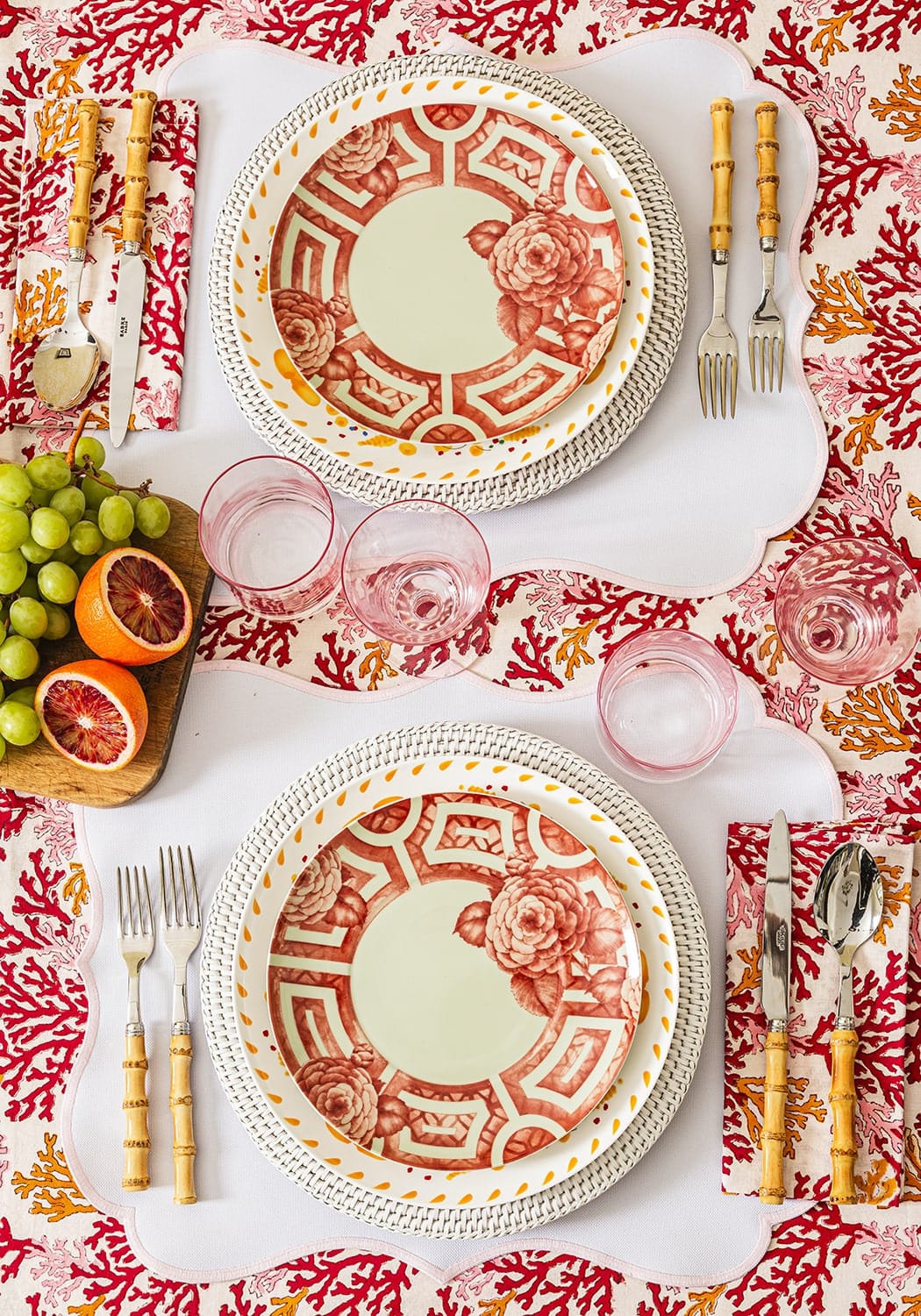 Red and white ceramic plates with intricate rose and geometric patterns complement rosa pink placemats set of 4