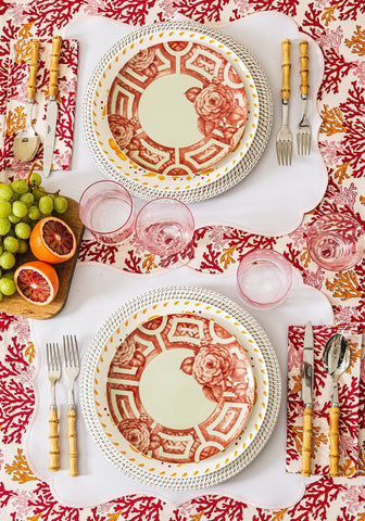 Red and white ceramic plates with intricate rose and geometric patterns complement rosa pink placemats set of 4