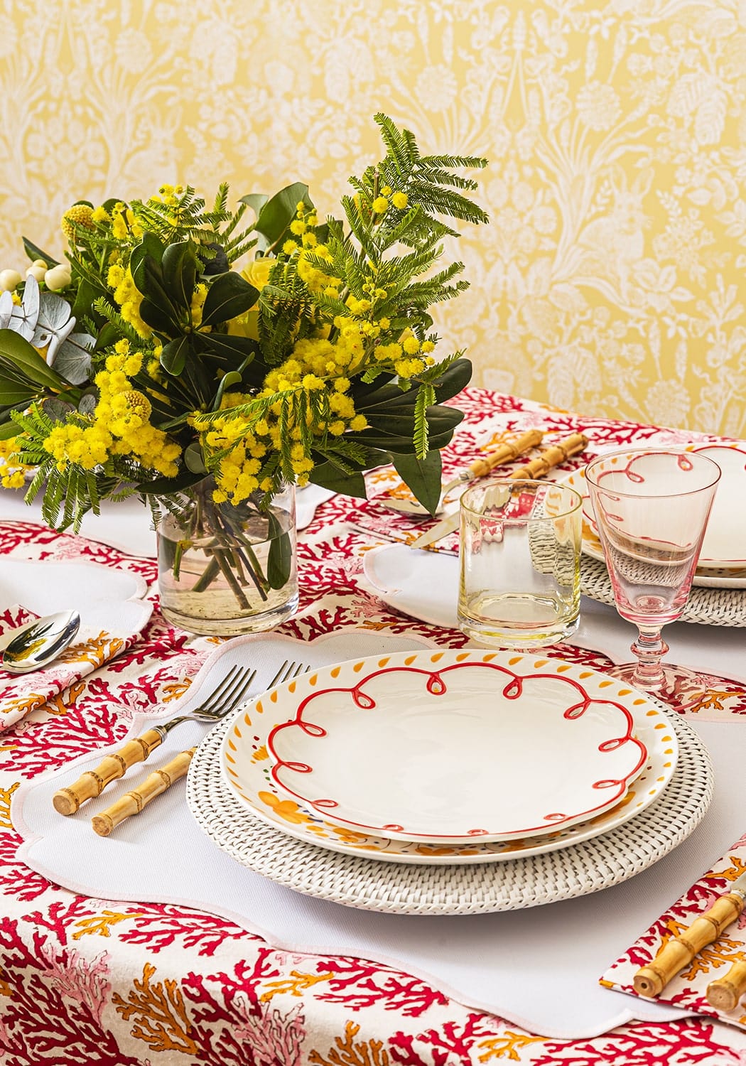 White ceramic plate with scalloped edge and red border on woven placemat from rosa pink placemats set of 4