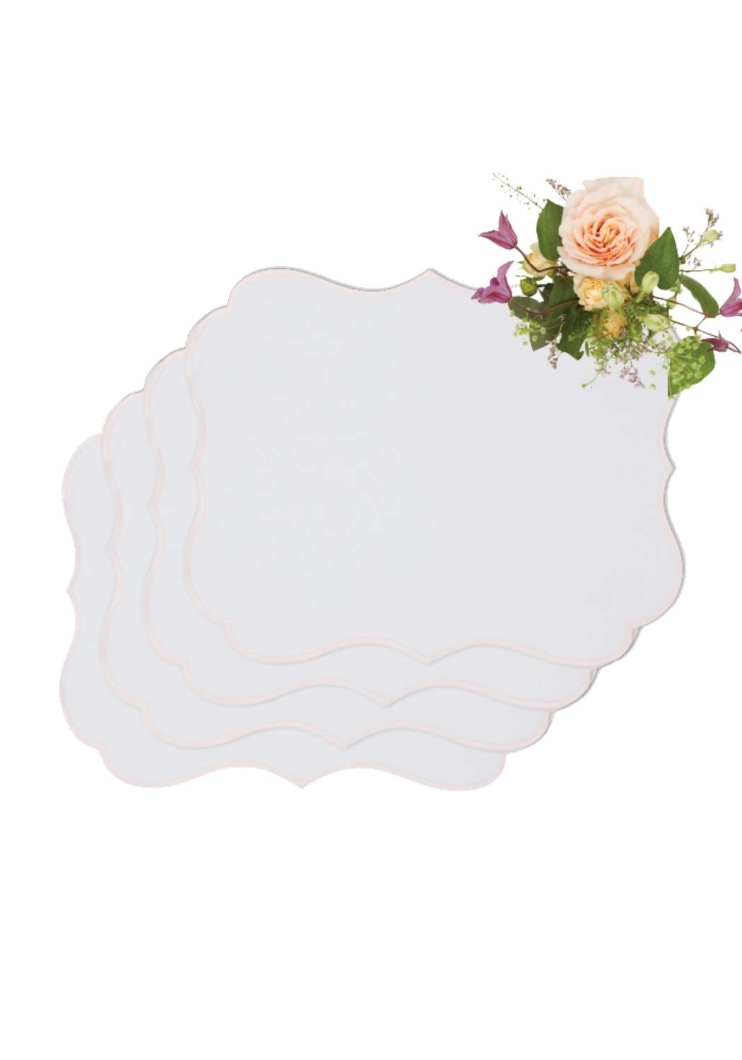 White scalloped-edged rosa pink placemats set of 4 with a soft peach and purple floral arrangement on top