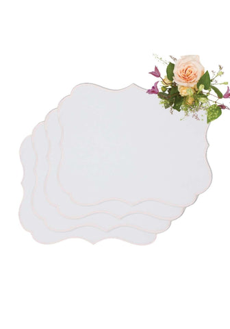 White scalloped-edged rosa pink placemats set of 4 with a soft peach and purple floral arrangement on top