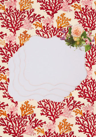 A white scalloped notepad with floral corner next to rosa pink placemats set of 4 for stylish table decor