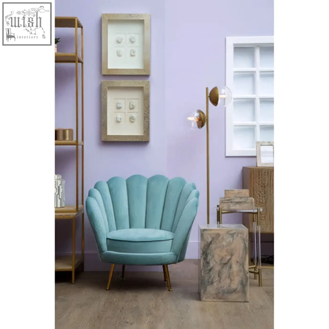 A teal velvet shell-shaped armchair with gold-tone legs paired with a rosado marble effect side table and stool