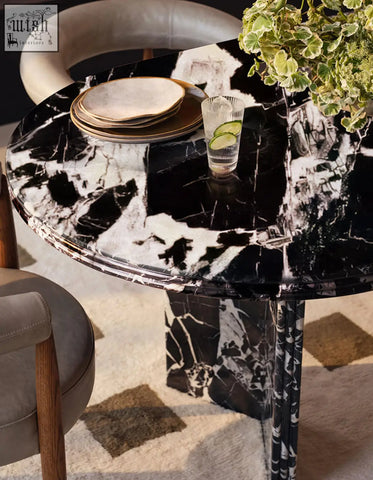 Rosaline black marble dining table oval with sleek modern legs featuring black and white marble dining surface