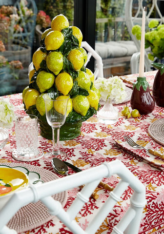 A vibrant glossy ceramic lemon tree centerpiece with green leaves and a dark green base for table decor