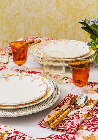 White ceramic plates with delicate pink scalloped edges and gold dot accents paired with rose coral table napkins set of 4