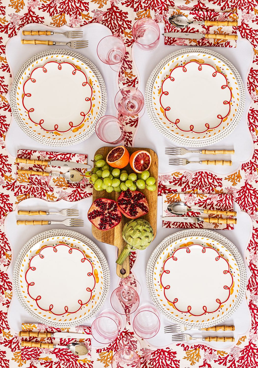 White ceramic plates with red and yellow decorative borders paired with rose coral table napkin set of 4