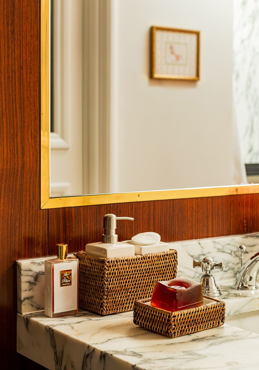 Woven brown rattan soap dish from rosies suds and style holding a translucent red bar of soap