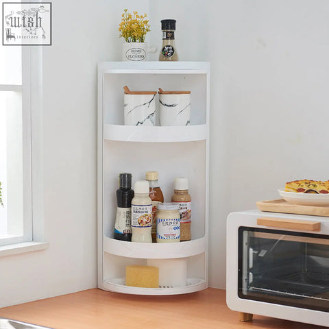 White rotatable bathroom makeup organizer corner shelf with three plastic curved tiers storing jars and bottles