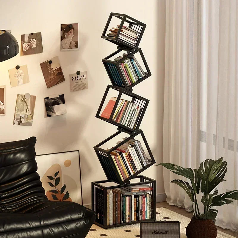 Black metal rotating cube bookshelf with staggered stacked books for modern stylish storage and display