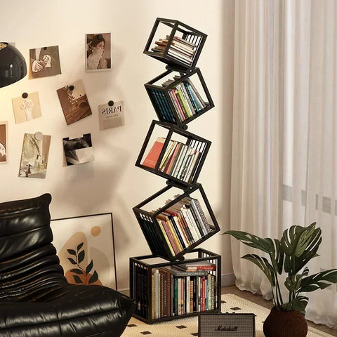 Black metal rotating cube bookshelf with staggered stacked books for modern stylish storage and display