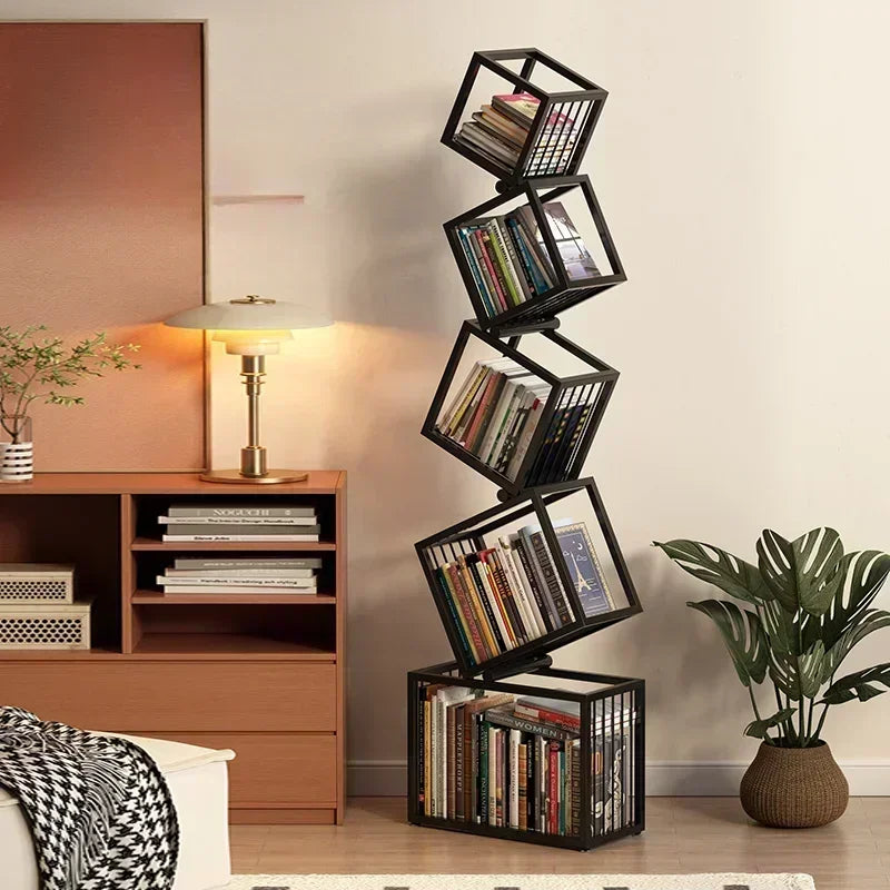 Black metal rotating cube bookshelf with books arranged in each tilted compartment for stylish storage