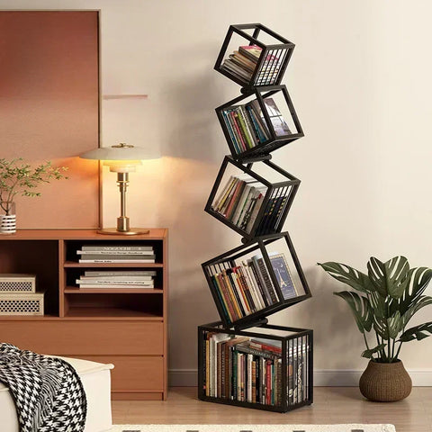 Black metal rotating cube bookshelf with books arranged in each tilted compartment for stylish storage