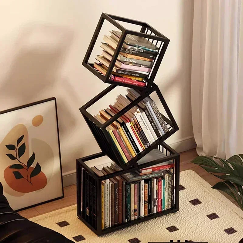Black metal rotating cube bookshelf with three stacked tilted sections holding books in a modern cube bookshelf design