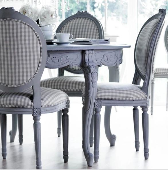 Gray hand made round capriolet leg dining table set with ornate carvings and checkered fabric upholstery chairs