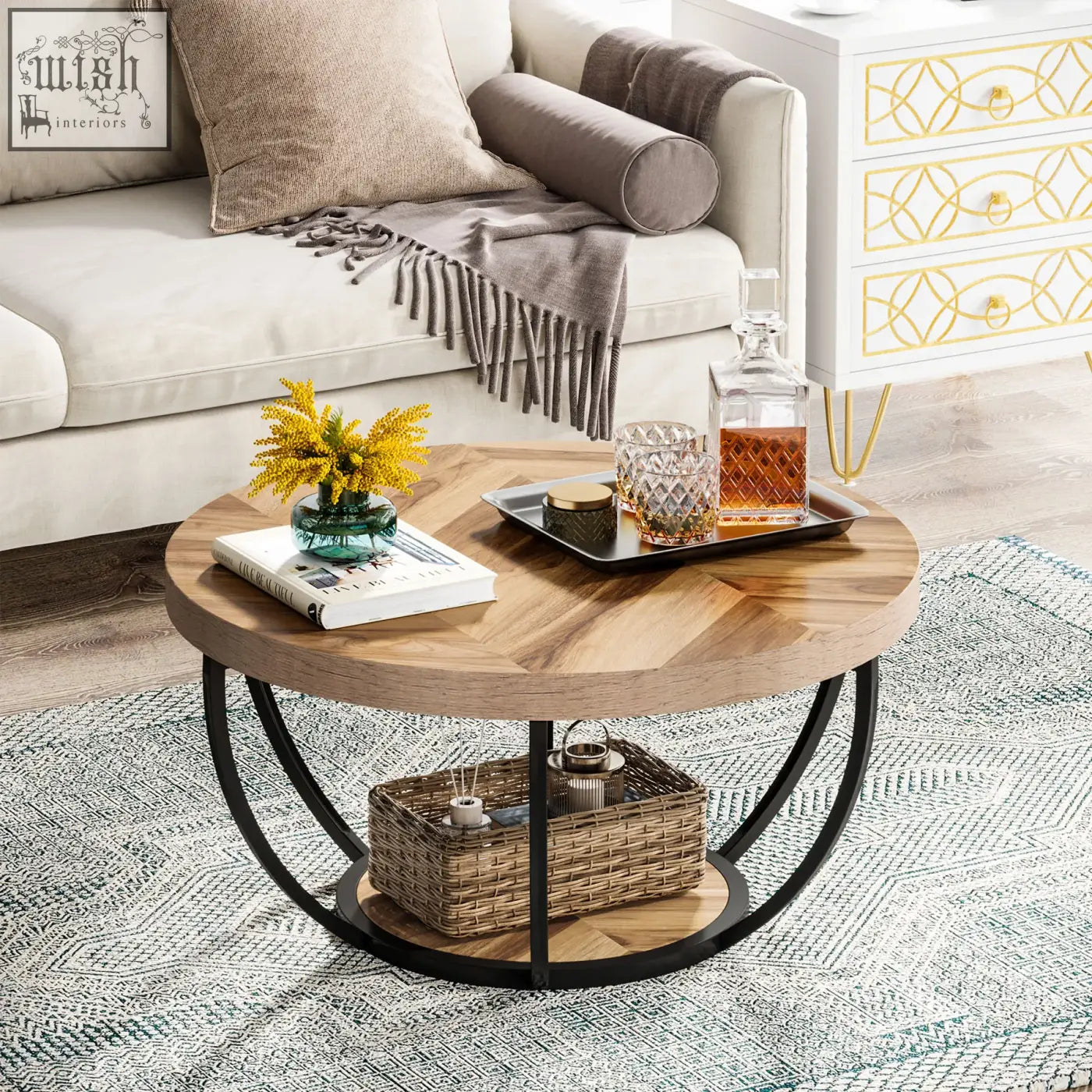 Round coffee table with light wood top black metal frame and open lower shelf holding woven basket