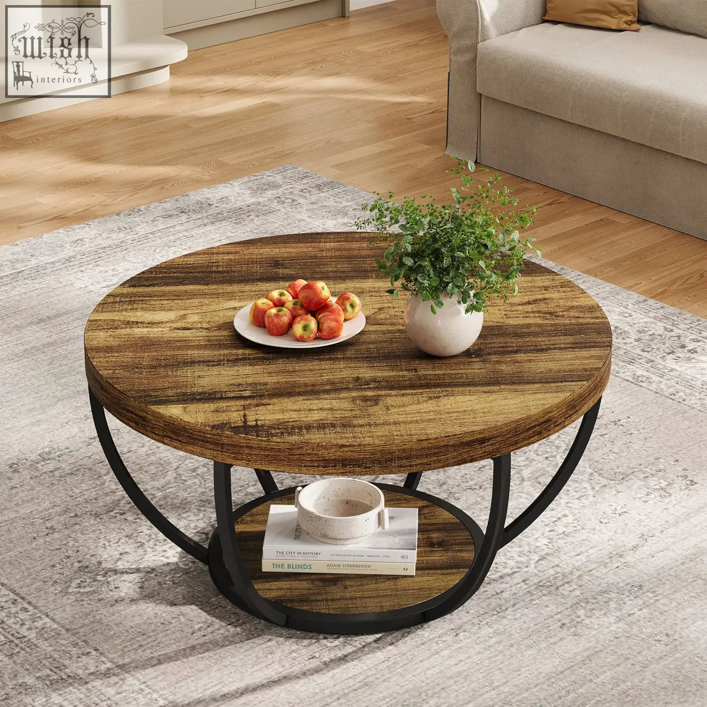 Rustic round coffee table with distressed wood top and black metal frame with an open lower shelf
