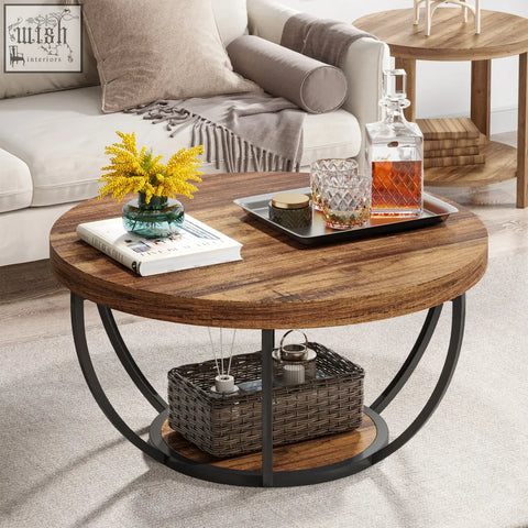 Round coffee table with wooden top black metal circular legs and lower shelf holding woven basket