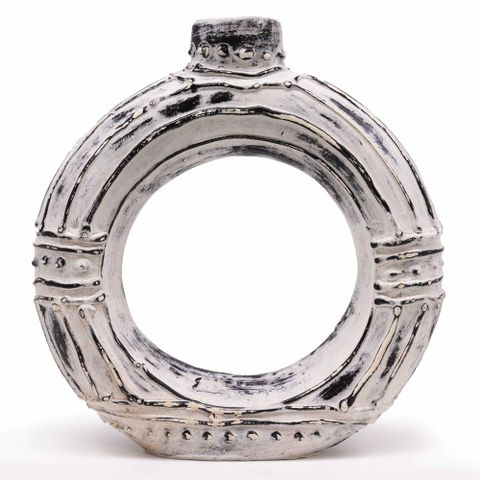 Silver textured ceramic ring with rustic handcrafted finish and beaded accents beside round donut shaped cream vase 30cm