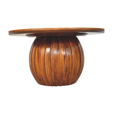 A sleek round wooden coffee table with polished amber finish and distinctive ribbed pedestal base