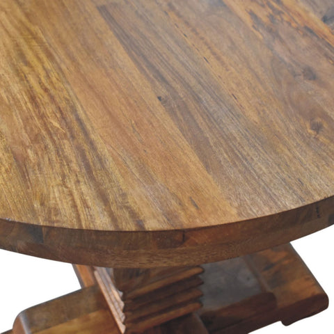 Rounded wooden dining table with a warm natural finish and visible grain patterns perfect for any dining space