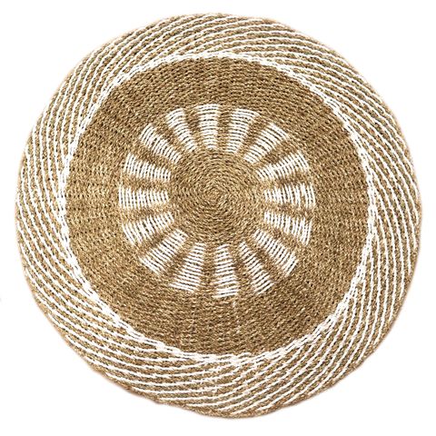 Handwoven round seagrass placemat with natural jute and white rope in a sunburst pattern for table decor