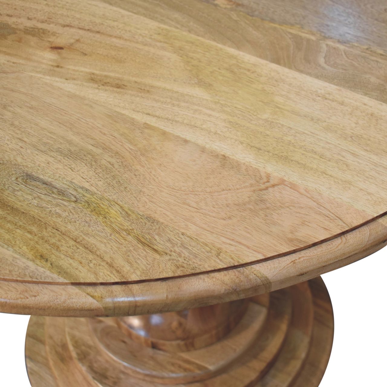 Round turned dining table made of light-colored wood with a smooth natural finish and visible grain patterns