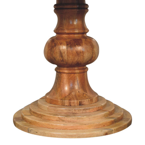 A polished medium brown wooden leg with turned design and tiered base for a round turned dining table