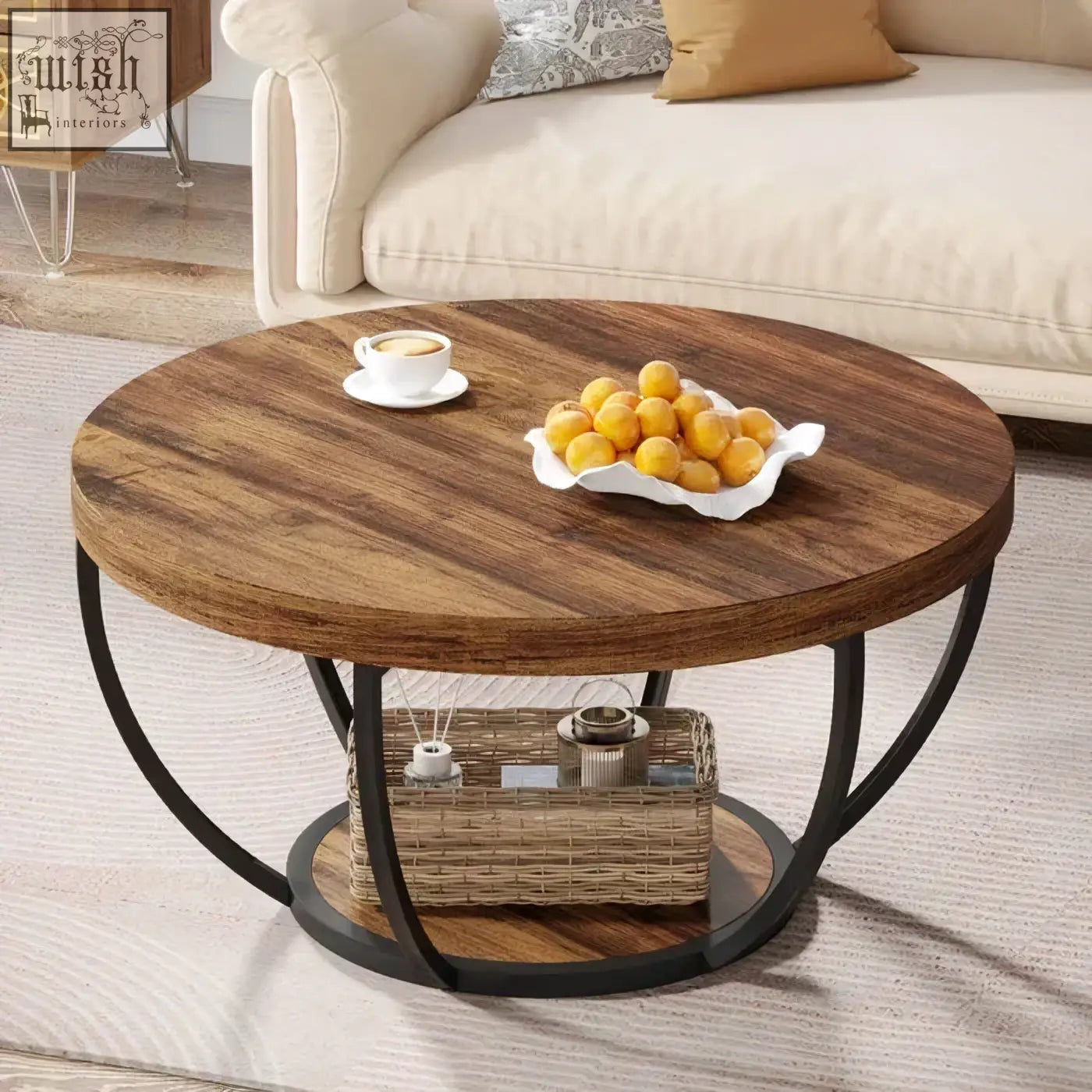 Round wooden coffee table with dark wood top black metal legs and open shelf holding woven basket