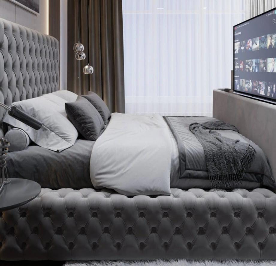 Gray tufted velvet royal tv bed with matching headboard and footboard fits tvs in king size bedroom setup