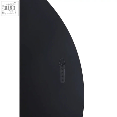 Black curved wall mirror with round wall shelf and small metal hook for stylish wall mirror display