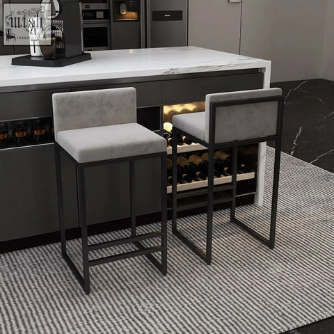 Ruby bar stool with modern gray upholstery and sleek wrought iron frame featuring high density padding