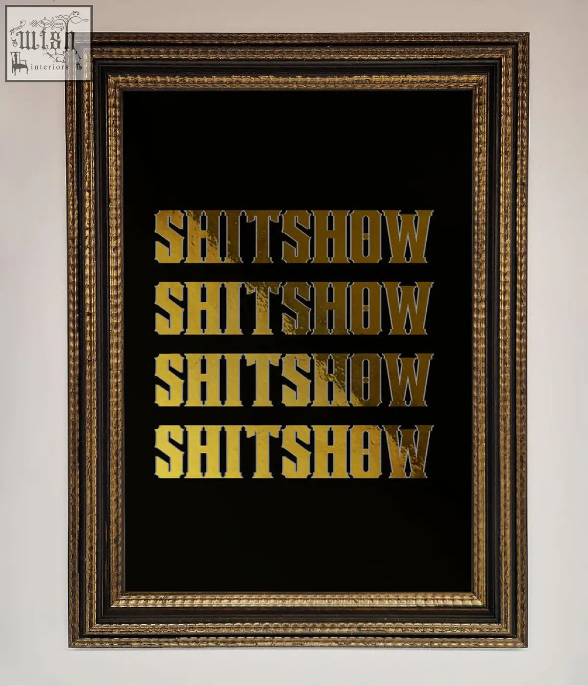 Rude quote foil print with gold foil lettering spelling shitshow repeated on black background in dark wood frame