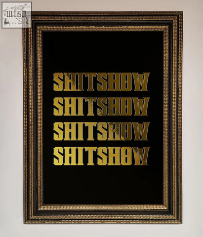 Rude quote foil print with gold foil lettering spelling shitshow repeated on black background in dark wood frame