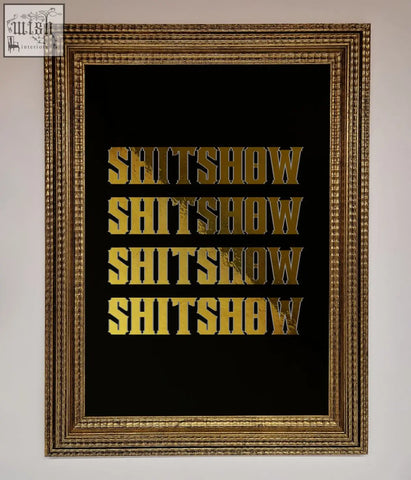 Gold-framed rude quote foil print with the word shitshow repeated in bold textured gold lettering on black background