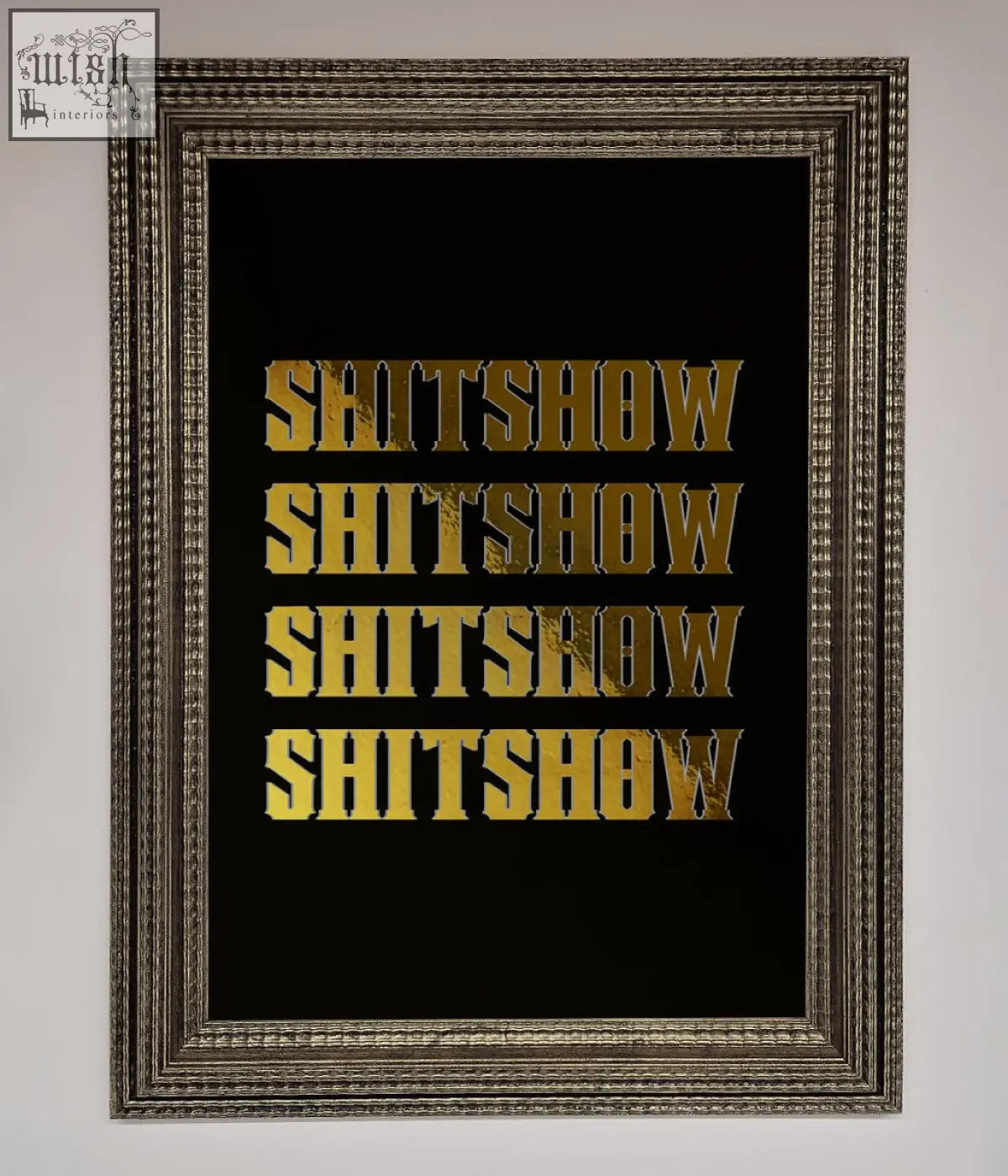 A rude quote foil print featuring the word shitshow repeated in bold gold foil on a black background in a frame