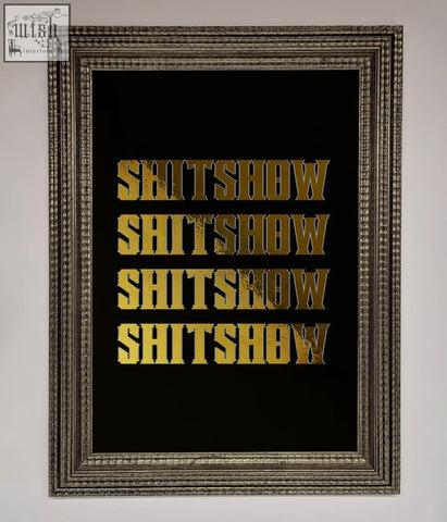 A rude quote foil print featuring the word shitshow repeated in bold gold foil on a black background in a frame
