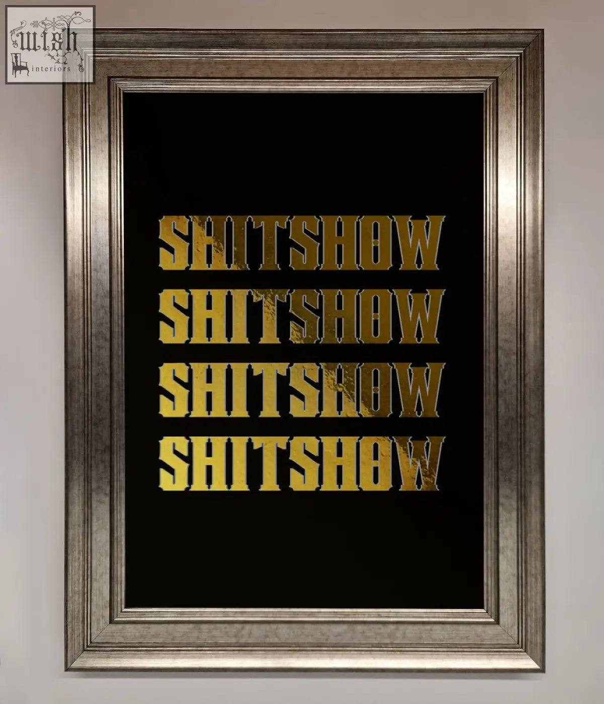 A framed rude quote foil print featuring bold textured gold lettering on black spelling shitshow repeated four times