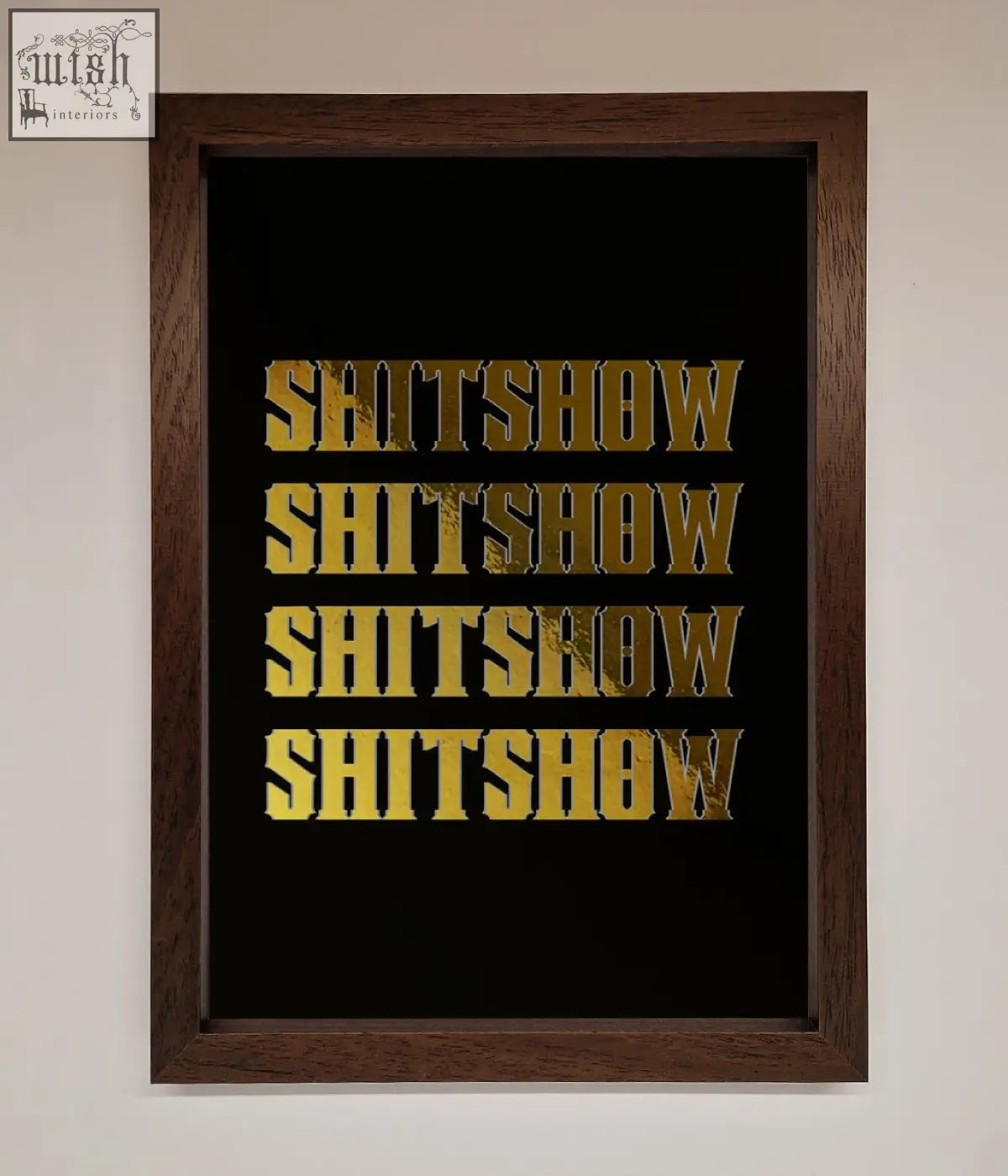 Dark wood-framed rude quote foil print with bold gold textured lettering on black background reading shitshow repeated four times