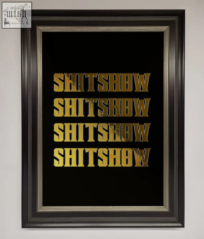Black framed rude quote foil print with gold foil lettering spelling shitshow repeated in bold blocky font