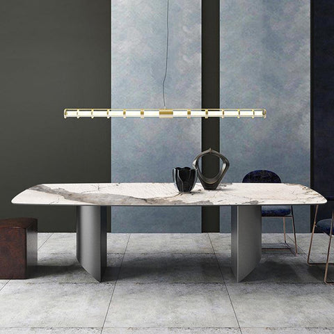 Modern rupert dining table with white marble top and gray veining on sleek minimalist metal legs
