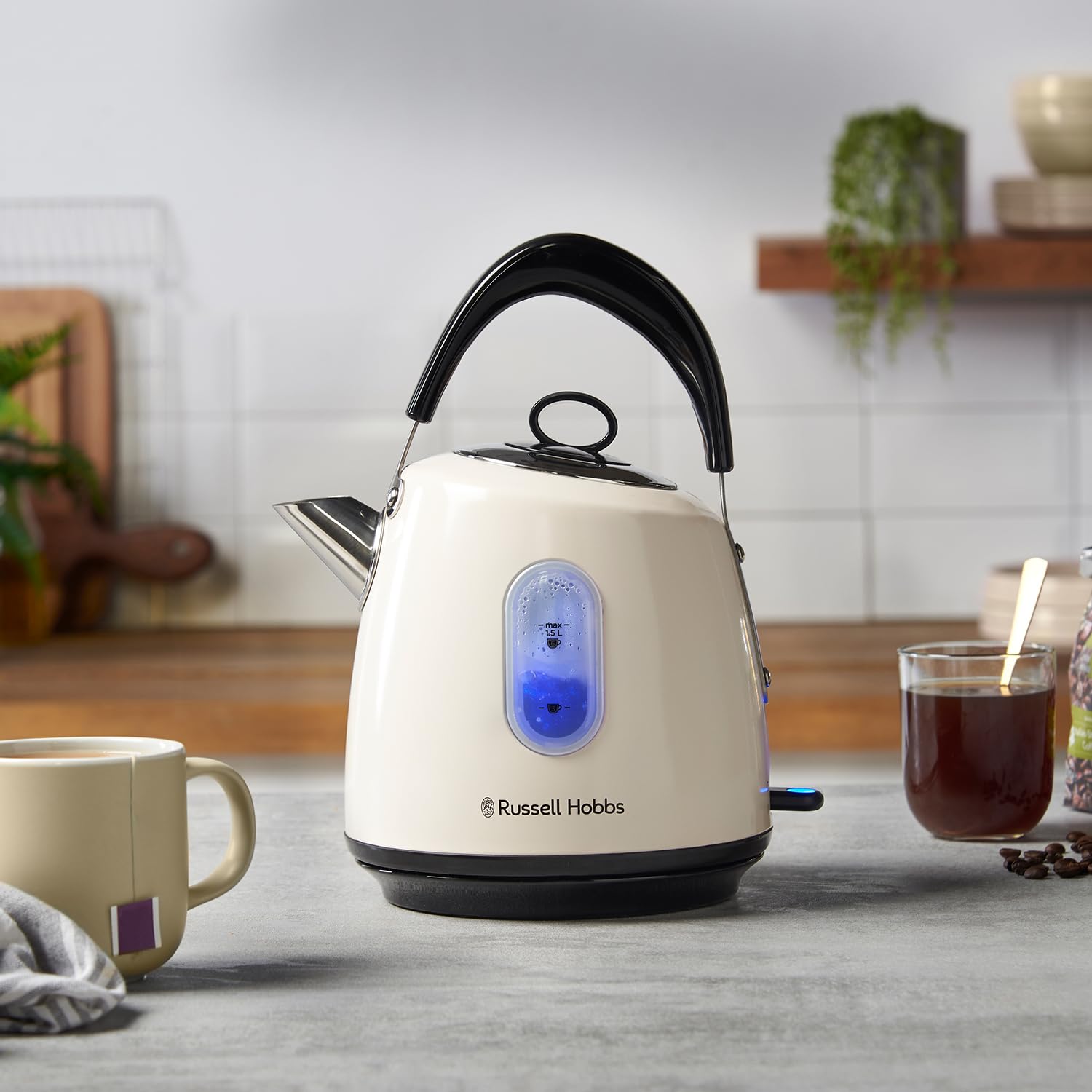 Cream-colored russell hobbs electric kettle with black handle and base featuring perfect pour spout and blue digital display