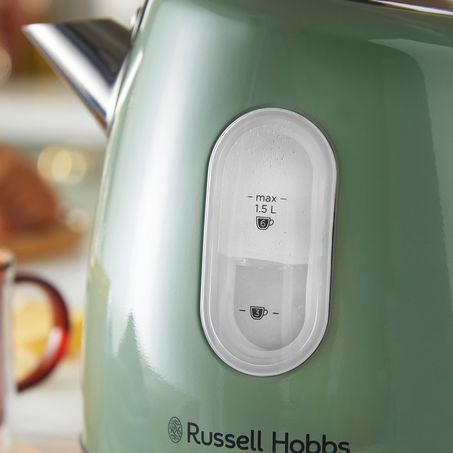 A matte sage green russell hobbs electric kettle with chrome spout white water level and perfect pour spout design
