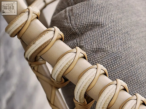 Beige leather straps intricately wrapped around the frame of the rustam modern outdoor rattan corner sofa set
