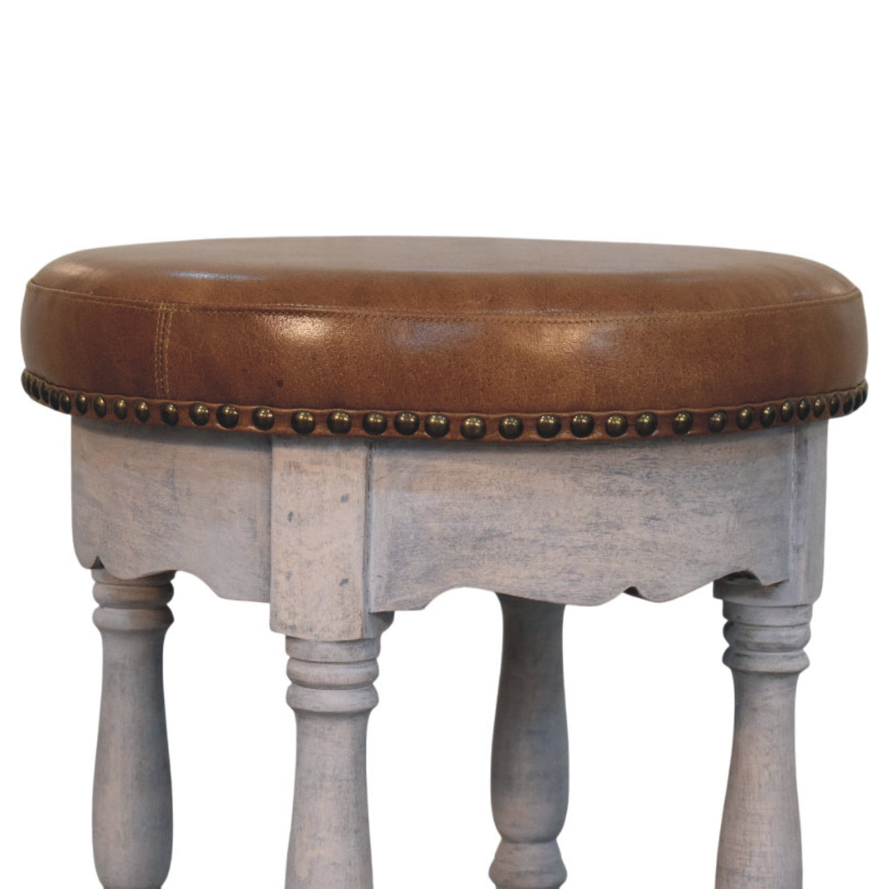 Rustic charm stool with brown leather top, distressed gray wooden legs, and brass nailhead trim
